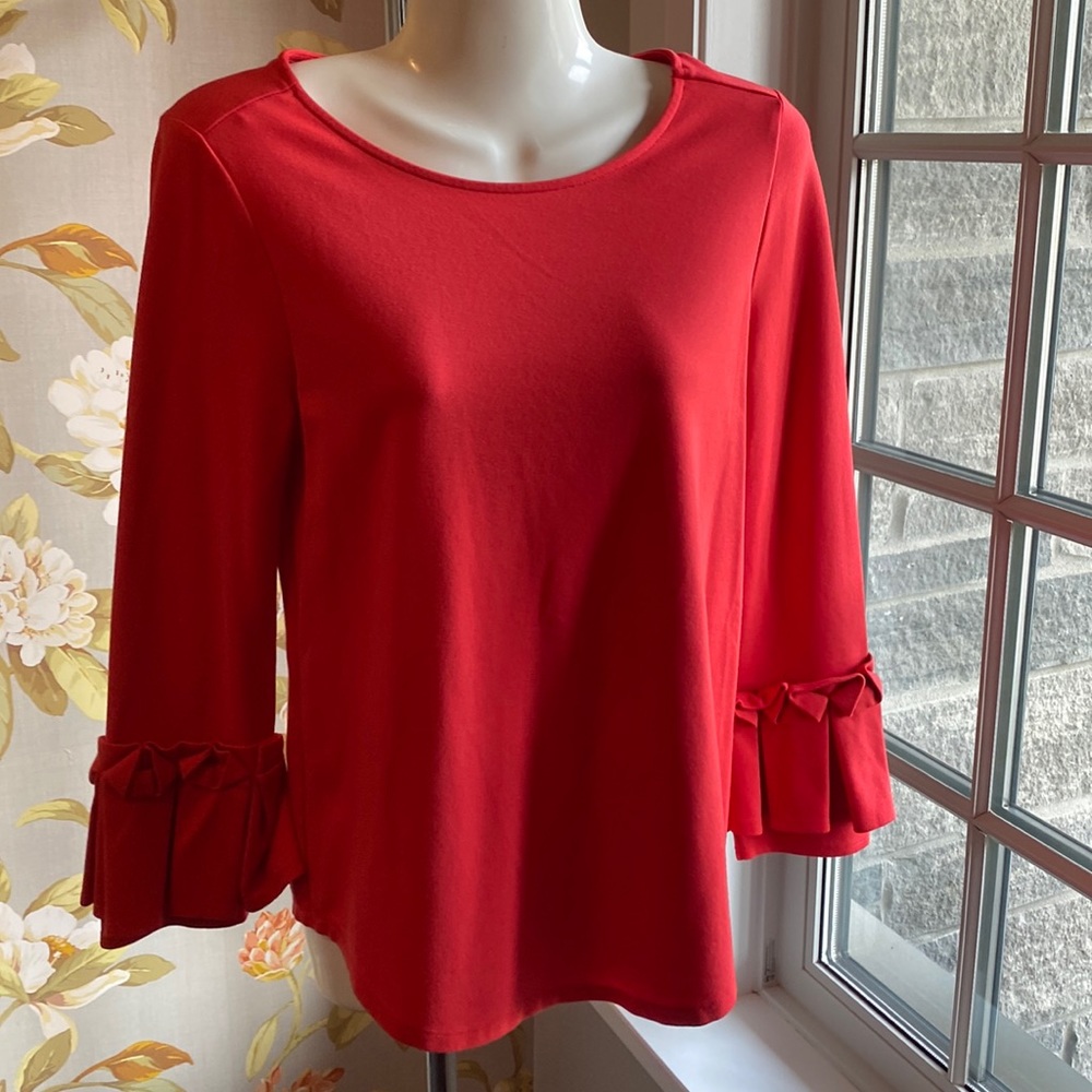Long sleeve top with ruffle on sleeve.